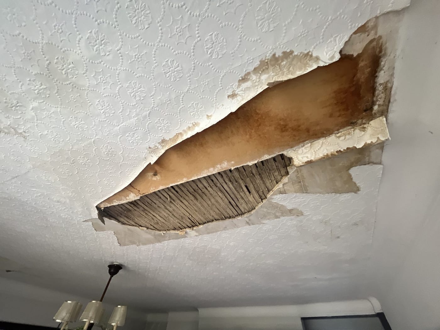 A ceiling collapsed to the bare lath